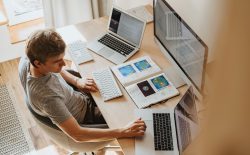 man at two computers