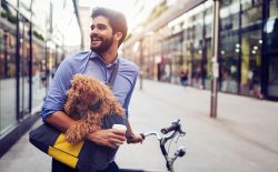 man carrying dog